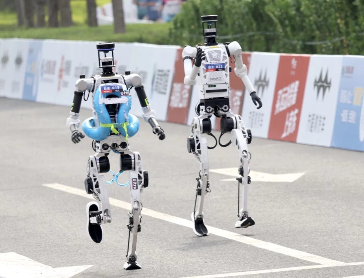 Some robot runners came prepared with safety gear in case of falls Some robot runners came prepared with safety gear in case of falls