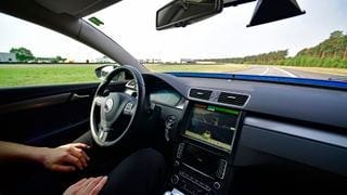 A person sitting in a self-driving car A person sitting in a self-driving car