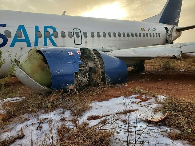 Shocking images revealed the plane operated by Senegalese carrier Transair nestled in the dirt with a gaping hole in the left engine that was covered in firefighting foam in the aftermath of the blaze Shocking images revealed the plane operated by Senegalese carrier Transair nestled in the dirt with a gaping hole in the left engine that was covered in firefighting foam in the aftermath of the blaze