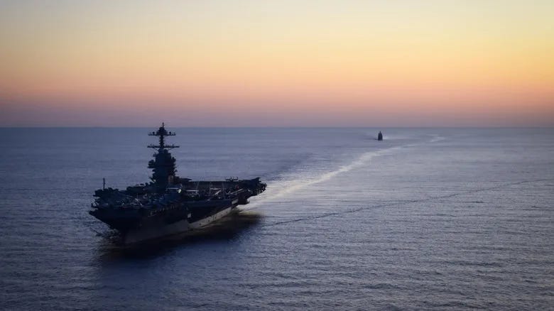 American aircraft carrier sailing away from the horizon. American aircraft carrier sailing away from the horizon.