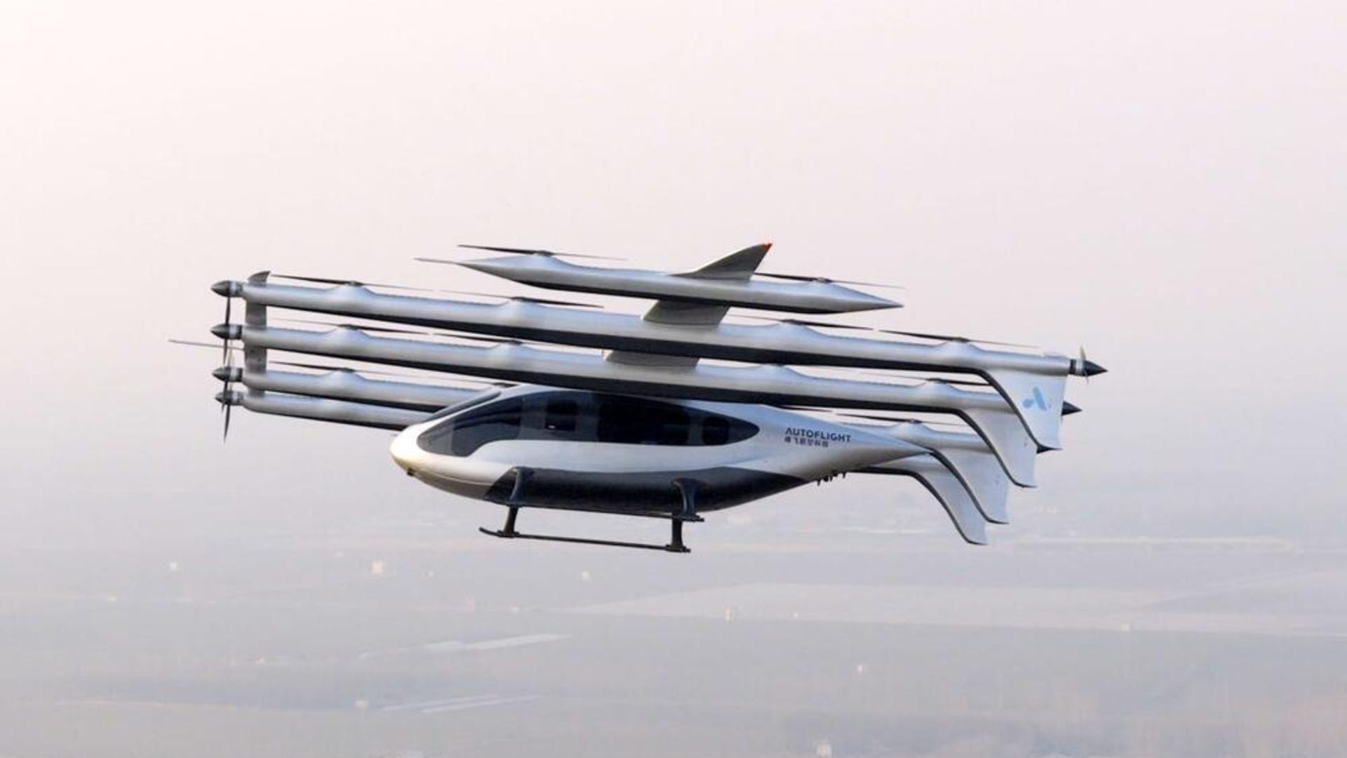 A sleek silvery aircraft flies over a smoggy cityscape with multiple propellors and tails. A sleek silvery aircraft flies over a smoggy cityscape with multiple propellors and tails.