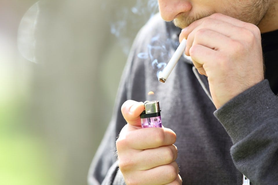 Teen hands lighting a cigarette to smoke Teen hands lighting a cigarette to smoke
