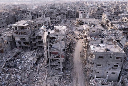 Palestinians walking through the destruction caused by the Israeli air and ground offensive, in Rafah, Gaza Strip, on 21 January 2025. Palestinians walking through the destruction caused by the Israeli air and ground offensive, in Rafah, Gaza Strip, on 21 January 2025.