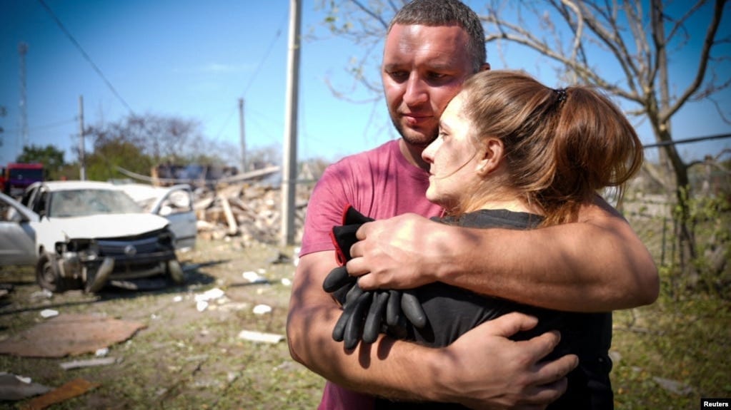 Local residents embrace each other at the site of a Russian missile strike in the Odesa region on August 26. Local residents embrace each other at the site of a Russian missile strike in the Odesa region on August 26.