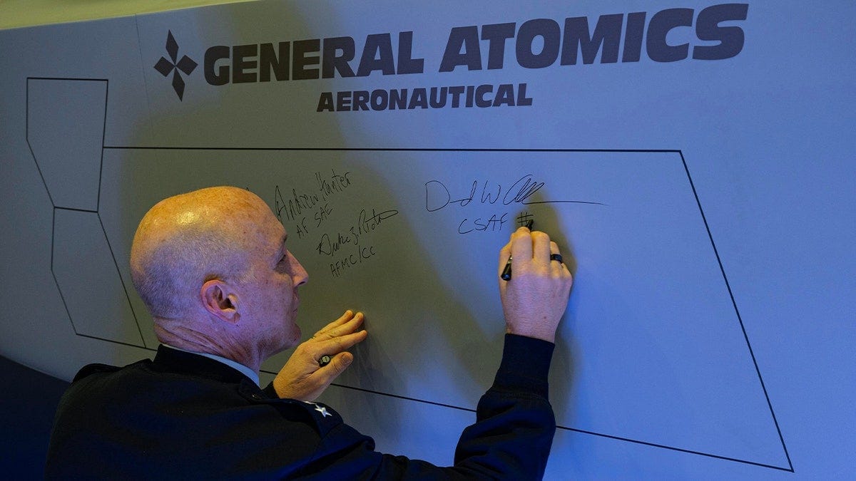 USAF general signs fighter jet USAF general signs fighter jet