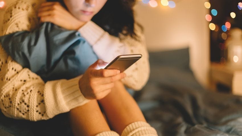 Girl texting on smartphone at home Girl texting on smartphone at home
