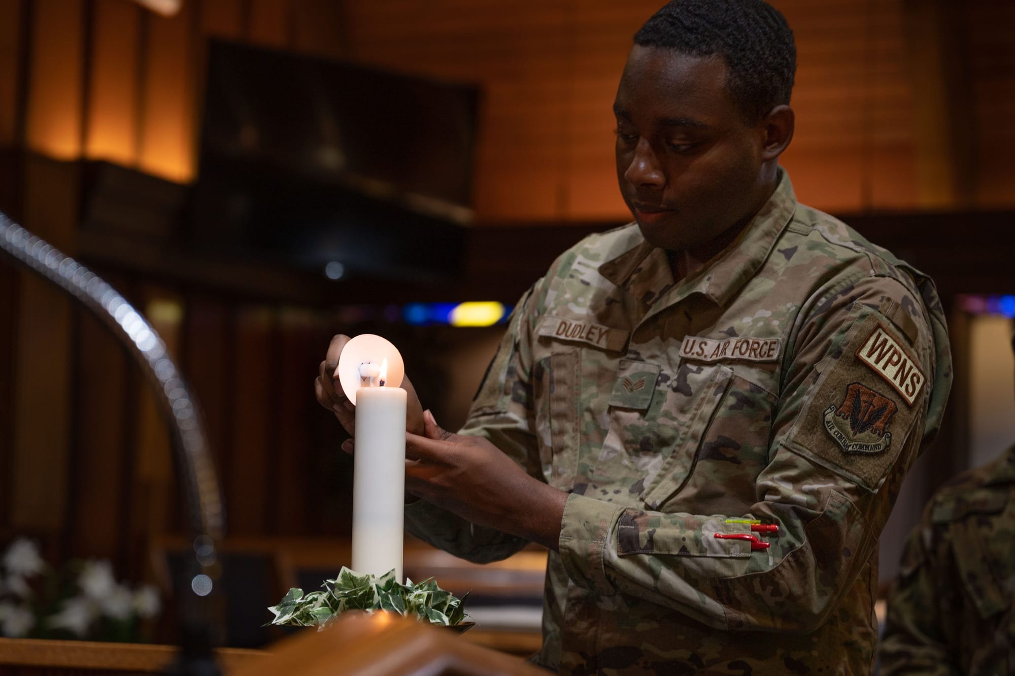 U.S. Air Force Senior Airman Azhmere Dudley, 57th Aircraft Maintenance Squadron weapons load crew member, lights a candle during a Holocaust Remembrance candle vigil at Nellis Air Force Base, Nevada, April 18, 2023. During the ceremony, candles were lit in honor of the victims of the Holocaust. (U.S. Air Force photo by Airman 1st Class Jordan McCoy) U.S. Air Force Senior Airman Azhmere Dudley, 57th Aircraft Maintenance Squadron weapons load crew member, lights a candle during a Holocaust Remembrance candle vigil at Nellis Air Force Base, Nevada, April 18, 2023. During the ceremony, candles were lit in honor of the victims of the Holocaust. (U.S. Air Force photo by Airman 1st Class Jordan McCoy)
