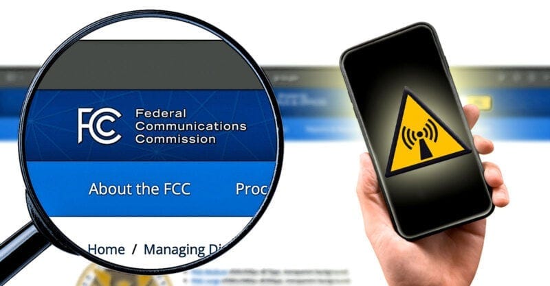 fcc in magnifying glass with hand holding cellphone with radiation symbol on top fcc in magnifying glass with hand holding cellphone with radiation symbol on top
