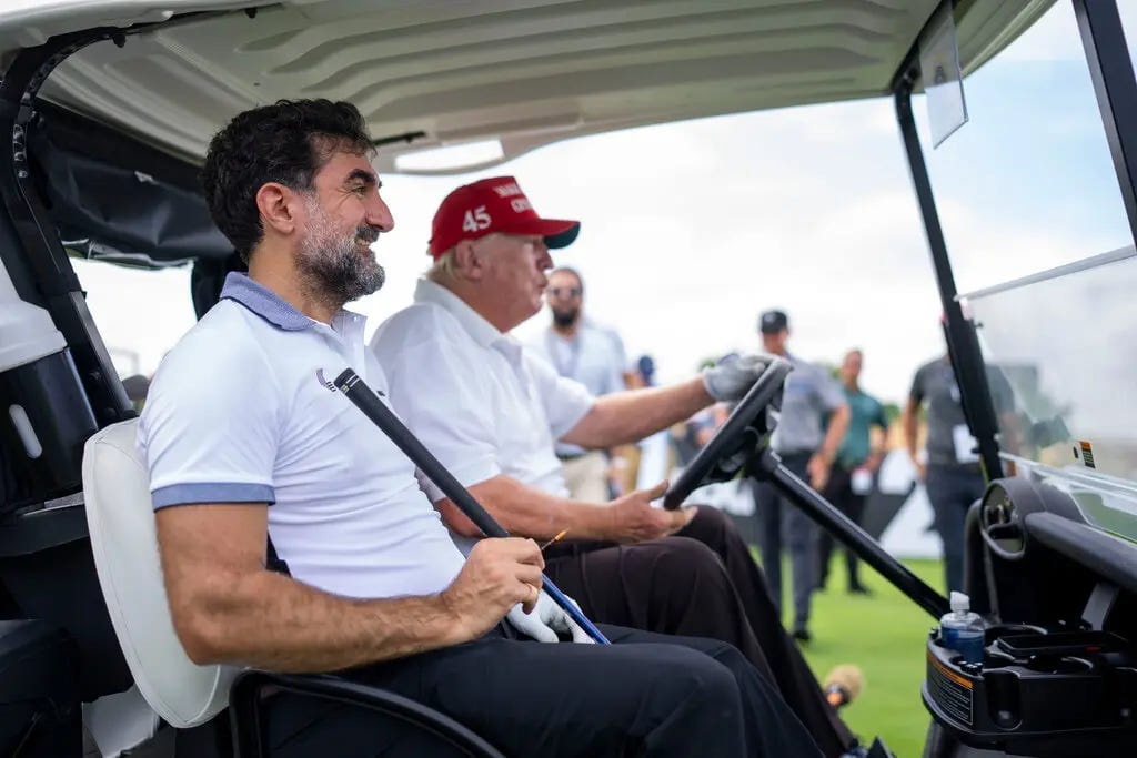 President Trump driving a golf cart with Yasir Al-Rumayyan sitting in the passenger seat. President Trump driving a golf cart with Yasir Al-Rumayyan sitting in the passenger seat.