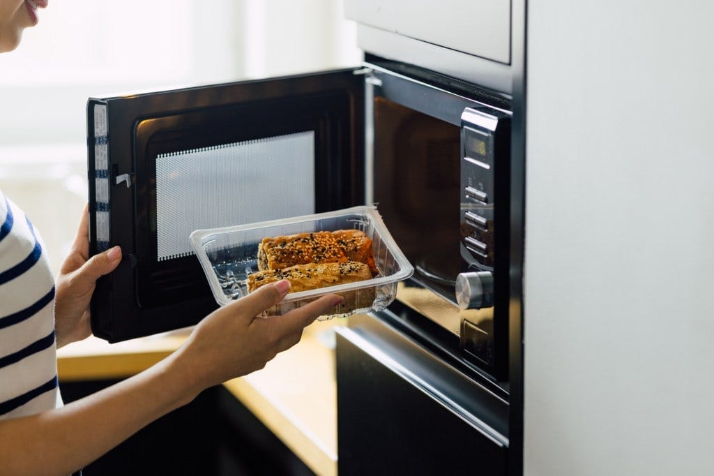 "Stopping the practice of heating food in plastic could be one of the most effective ways to reduce microplastic consumption," the researchers wrote. A woman is shown reheating a meal in a microwave. "Stopping the practice of heating food in plastic could be one of the most effective ways to reduce microplastic consumption," the researchers wrote. A woman is shown reheating a meal in a microwave.