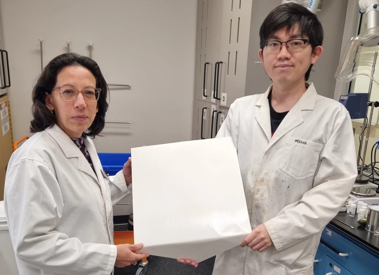 Professor Chiara Neto (left) and Dr Ming Chiu hold one of the experimental tiles with the paint-like substance in their labs at the University of Sydney Professor Chiara Neto (left) and Dr Ming Chiu hold one of the experimental tiles with the paint-like substance in their labs at the University of Sydney