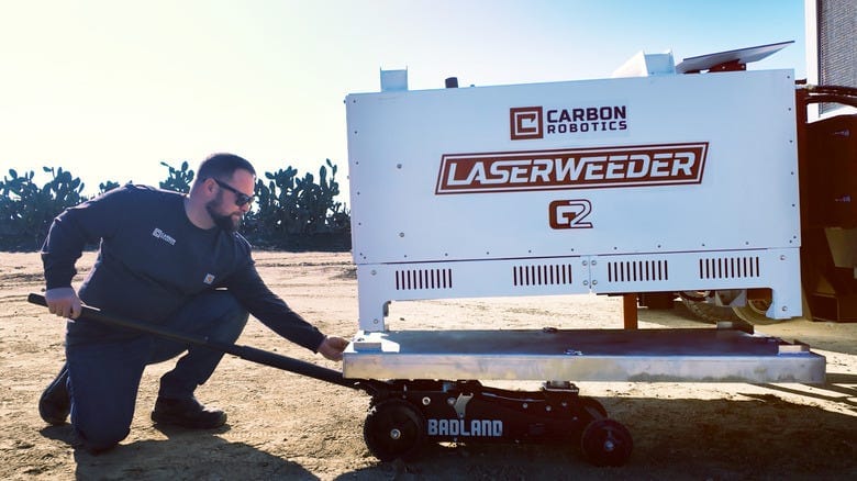 A person adjusting the Laserweeder G2 robot A person adjusting the Laserweeder G2 robot