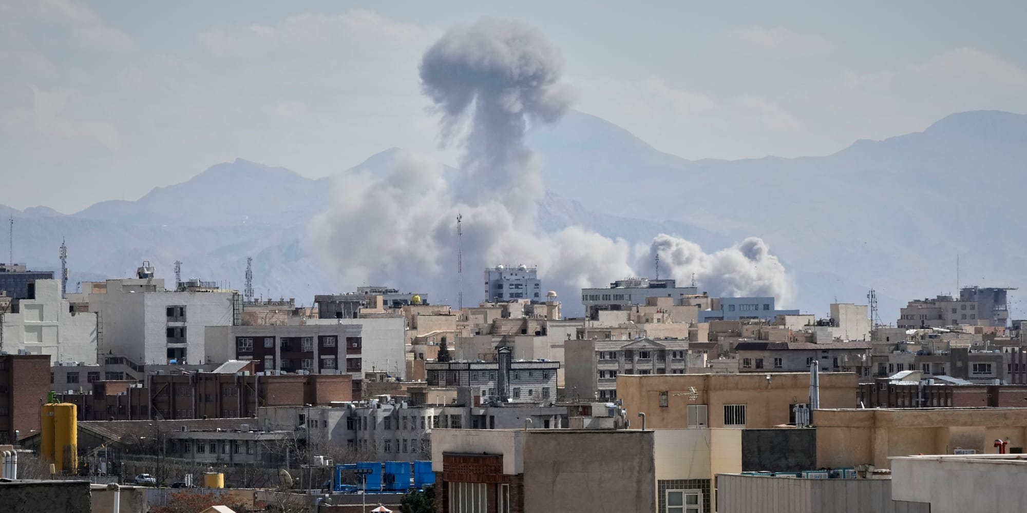 People watch from a rooftop as a plume of smoke rises after a strike in Tehran, Iran, Sunday, March 1, 2026. People watch from a rooftop as a plume of smoke rises after a strike in Tehran, Iran, Sunday, March 1, 2026.