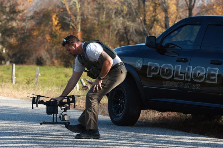 A law enforcement official sets up a drone as police conduct a manhunt for a mass shooting suspect in Monmouth, Maine, in October 2023. A law enforcement official sets up a drone as police conduct a manhunt for a mass shooting suspect in Monmouth, Maine, in October 2023.