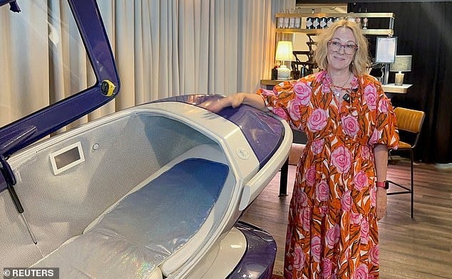 Fiona Stewart, member of the Last Resort poses next to the Sarco suicide machine in July Fiona Stewart, member of the Last Resort poses next to the Sarco suicide machine in July