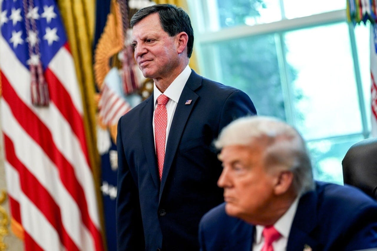 Frank Bisignano, head of the IRS and Social Security Administration, stands next to US President Donald Trump in the Oval Office.