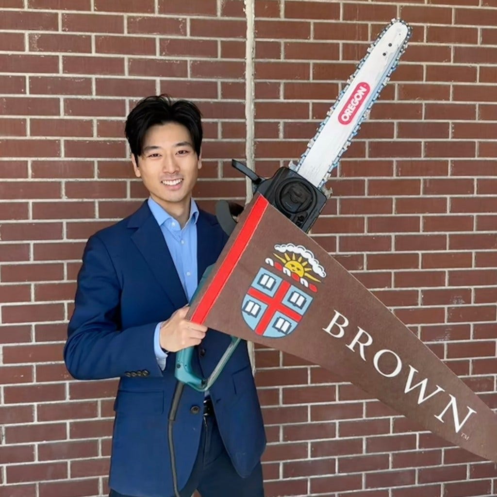 Alex Shieh with a chainsaw and brown university flag Alex Shieh with a chainsaw and brown university flag