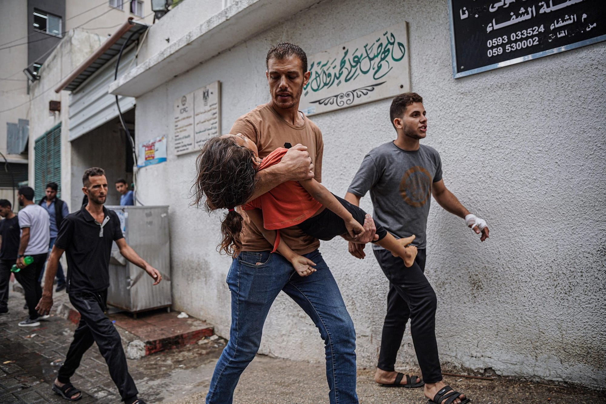 A Palestinian man carrying his daughter's body near Al-Shifa hospital, Oct. 9. She was killed by an airstrike. A Palestinian man carrying his daughter's body near Al-Shifa hospital, Oct. 9. She was killed by an airstrike.