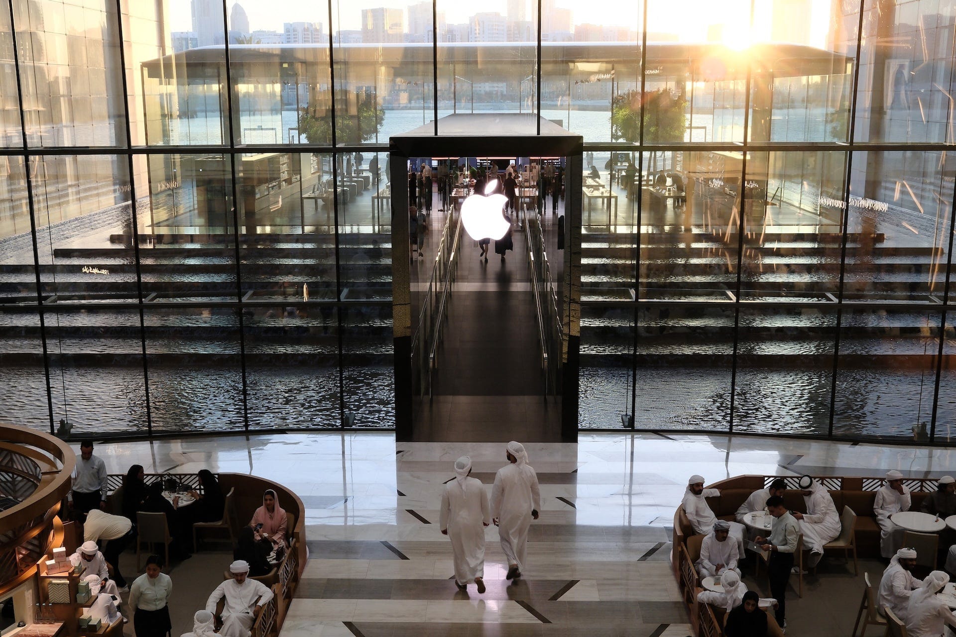 People sit in a cafe outside an Apple Store in the UAE on May 8, 2025. People sit in a cafe outside an Apple Store in the UAE on May 8, 2025.