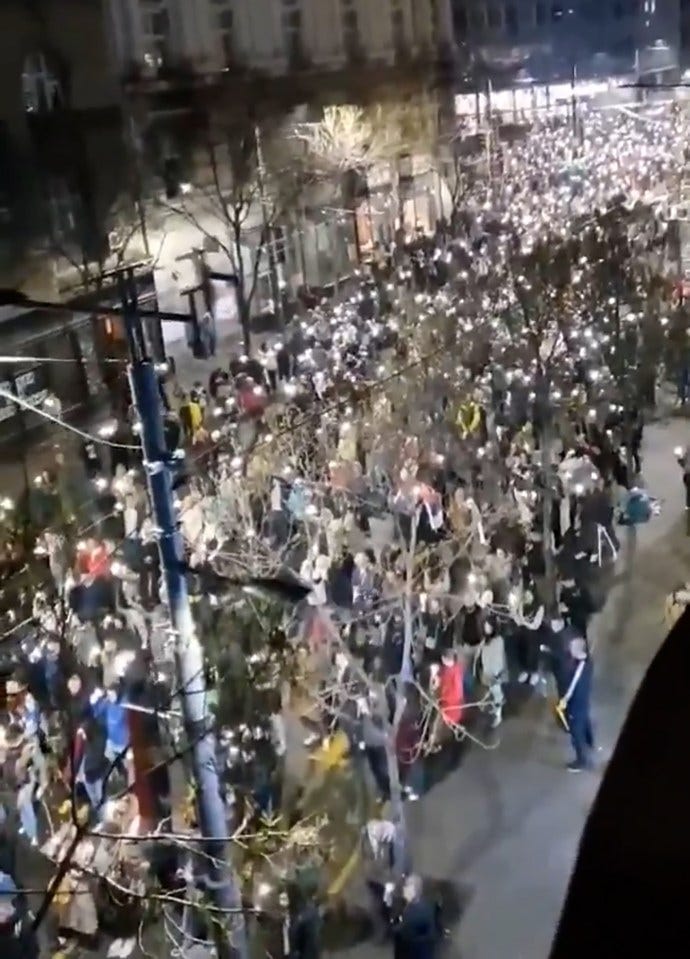 Protesters in Belgrade reacting to a sound during a demonstration. Protesters in Belgrade reacting to a sound during a demonstration.