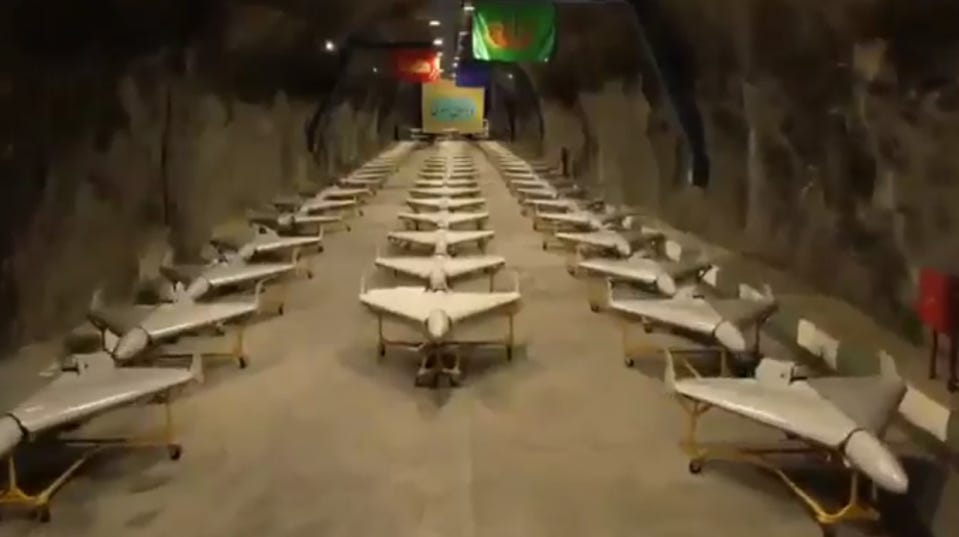 A large underground bunker filled with rows of drones on display. A large underground bunker filled with rows of drones on display.