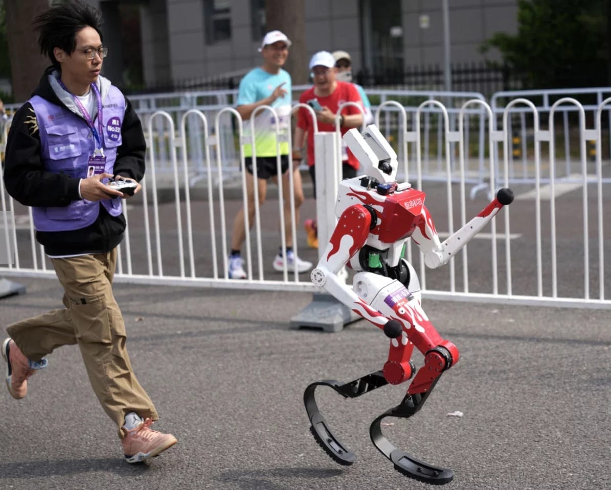 Team members with remote controls also had to run the distance behind their bots Team members with remote controls also had to run the distance behind their bots