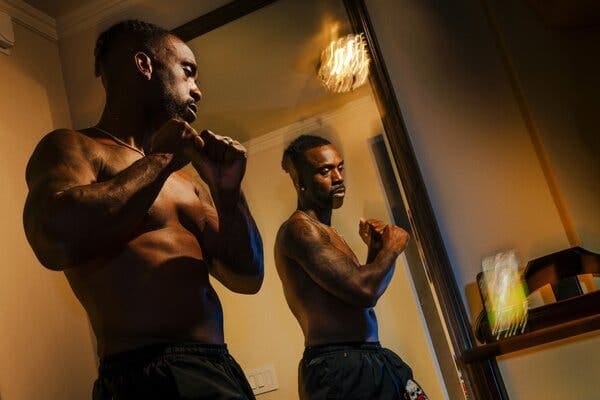 McCutchen, shirtless, practicing his stance in a mirror. McCutchen, shirtless, practicing his stance in a mirror.