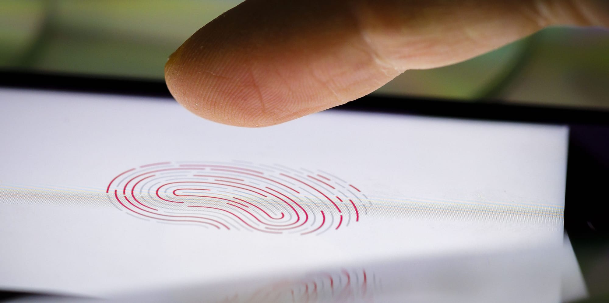 A finger hovers above an iPhone displaying an image of a fingerprint on February 18, 2020 in Berlin, Germany. A finger hovers above an iPhone displaying an image of a fingerprint on February 18, 2020 in Berlin, Germany.