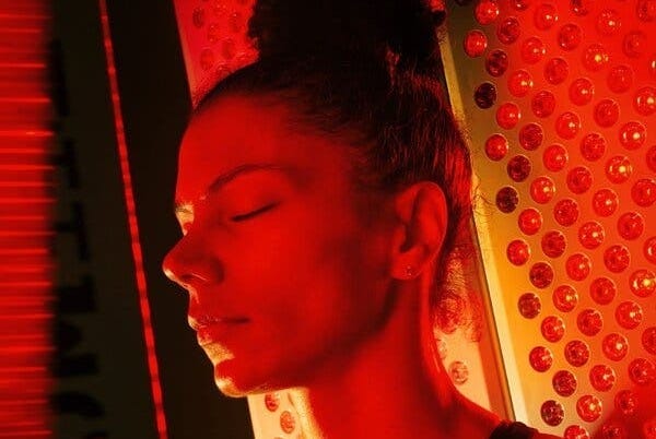 Alysha Clark stands in a recovery room with her eyes closed, bathed in red light. Alysha Clark stands in a recovery room with her eyes closed, bathed in red light.