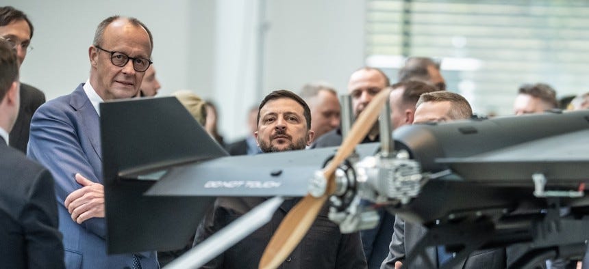 Ukrainian President Volodymyr Zelenskyy inspects a drone with German Federal Chancellor Friedrich Merz at an exhibition of German-Ukrainian products in the Federal Chancellery on April 14, 2026.