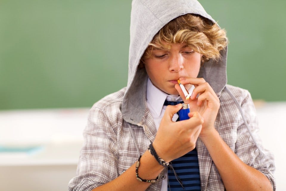 bad high school teen boy lighting cigarette in classroom Copyright: Getty Images - Getty bad high school teen boy lighting cigarette in classroom Copyright: Getty Images - Getty
