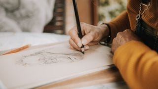 An artist drawing with pencils An artist drawing with pencils