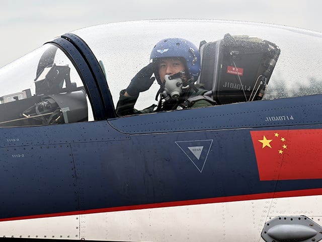 CHANGCHUN, CHINA - AUGUST 29: A pilot in a J-10 fighter jet of the Bayi Aerobatics Team of