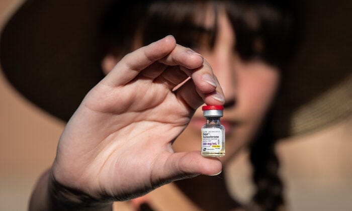 Chloe Cole, an 18-year-old woman who regrets surgically removing her breasts, holds testosterone medication used for transgender patients in Northern California on Aug. 26, 2022. (John Fredricks/The Epoch Times) Chloe Cole, an 18-year-old woman who regrets surgically removing her breasts, holds testosterone medication used for transgender patients in Northern California on Aug. 26, 2022. (John Fredricks/The Epoch Times)