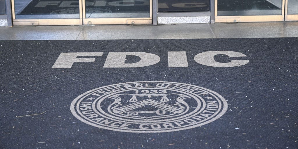 The entrance of a building with the FDIC logo on the floor. The entrance of a building with the FDIC logo on the floor.