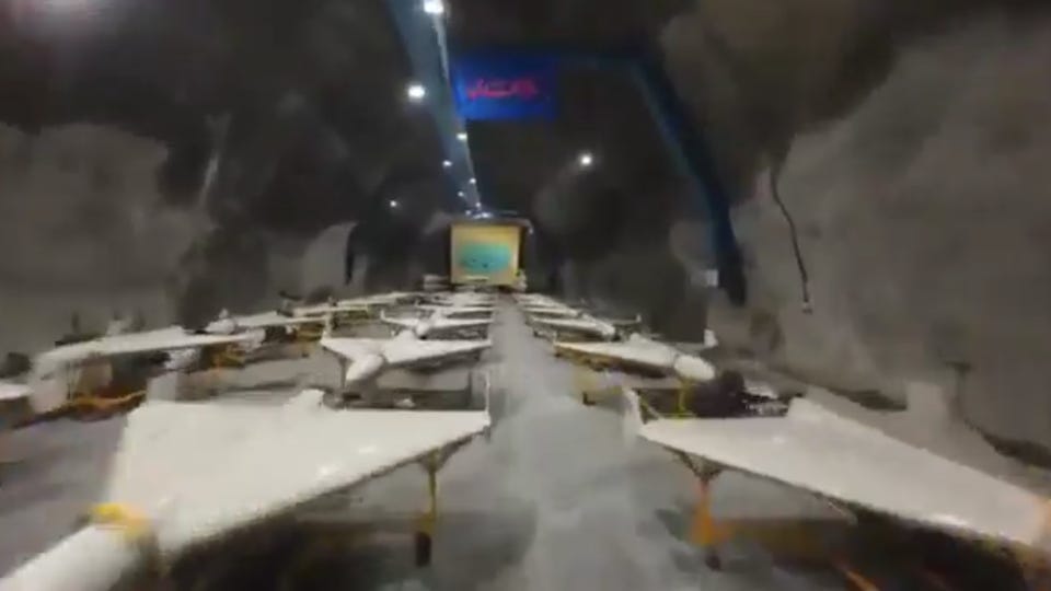 Underground bunker containing rows of white drones. Underground bunker containing rows of white drones.