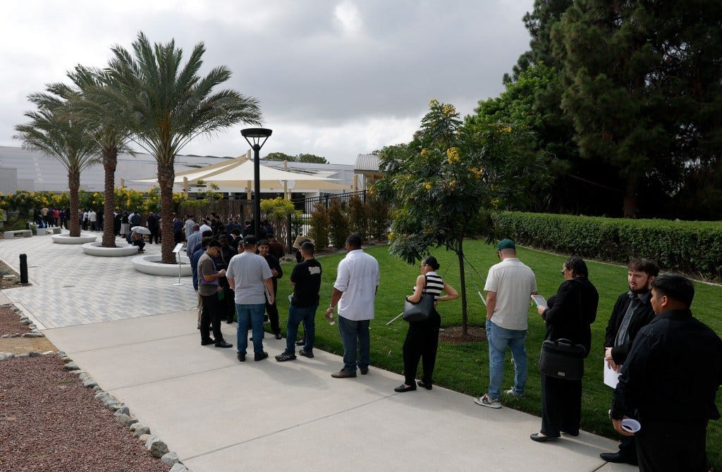 People waiting in line to enter a job fair in Los Angeles. People waiting in line to enter a job fair in Los Angeles.