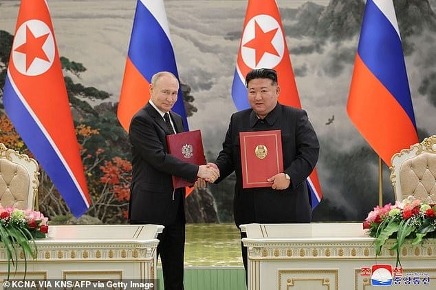 Kim Jong Un (R) and Russia's President Vladimir Putin (L) shaking hands after a signing ceremony following their bilateral talks on June 19 Kim Jong Un (R) and Russia's President Vladimir Putin (L) shaking hands after a signing ceremony following their bilateral talks on June 19