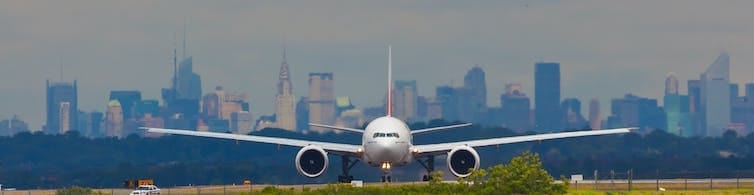 Boeing 777 with Manhattan in the background lining up on at JFK airport in New York. Boeing 777 with Manhattan in the background lining up on at JFK airport in New York.