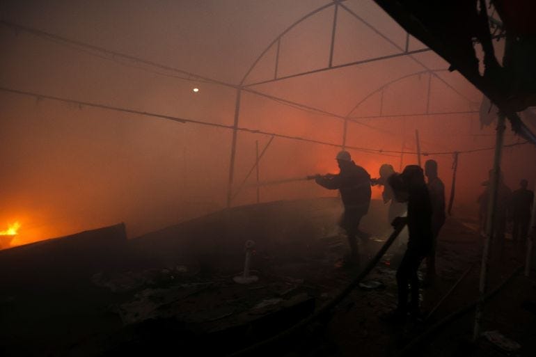 People attempt to extinguish a fire at the site of an Israeli strike on tents sheltering displaced people, amid the Israel-Hamas conflict, in Deir Al-Balah in the central Gaza Strip, October 14, 2024. REUTERS/Ramadan Abed People attempt to extinguish a fire at the site of an Israeli strike on tents sheltering displaced people, amid the Israel-Hamas conflict, in Deir Al-Balah in the central Gaza Strip, October 14, 2024. REUTERS/Ramadan Abed