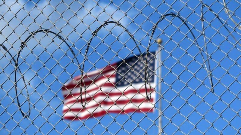 A U.S. flag flies behind barbed wire at the Guantánamo Bay naval base in Cuba. | Magdalena Miriam Tröndle/dpa/picture-alliance/Newscom A U.S. flag flies behind barbed wire at the Guantánamo Bay naval base in Cuba. | Magdalena Miriam Tröndle/dpa/picture-alliance/Newscom