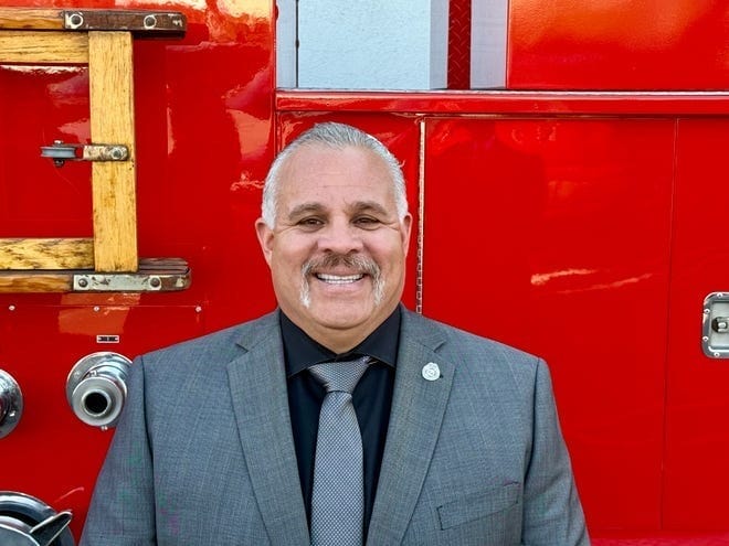 Fire Captain Freddy Escobar pictured in front of a fire truck Fire Captain Freddy Escobar pictured in front of a fire truck