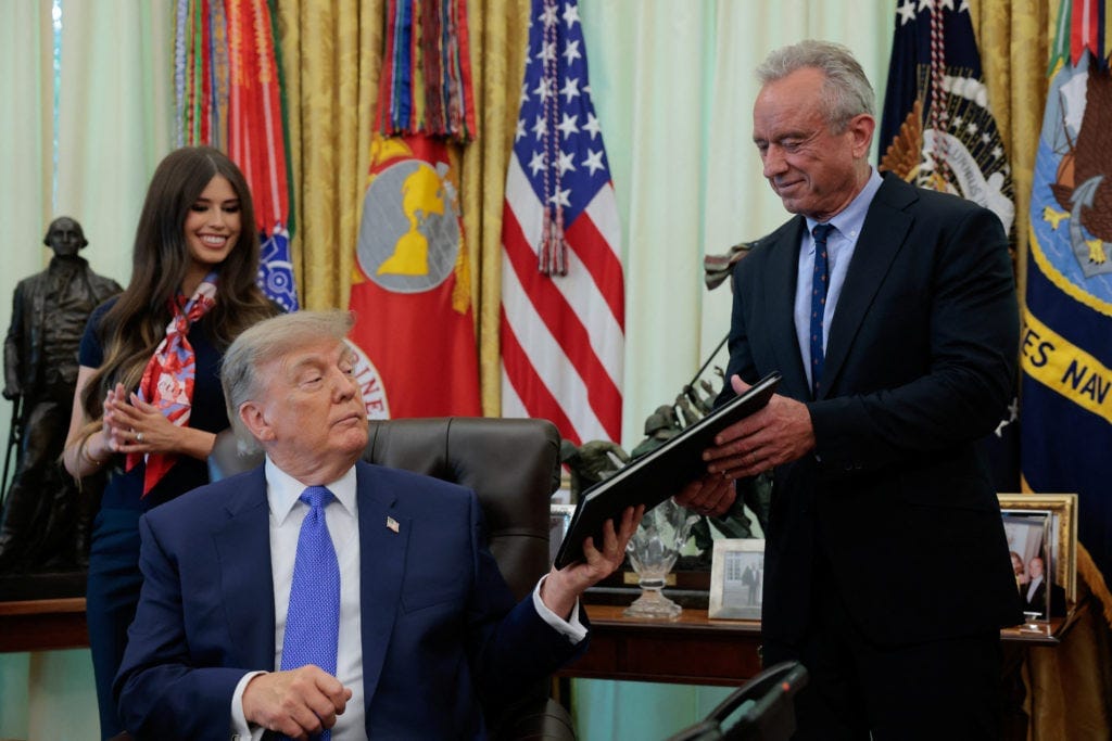U.S. President Donald Trump signs an executive order in the Oval Office at the White House in Washington
