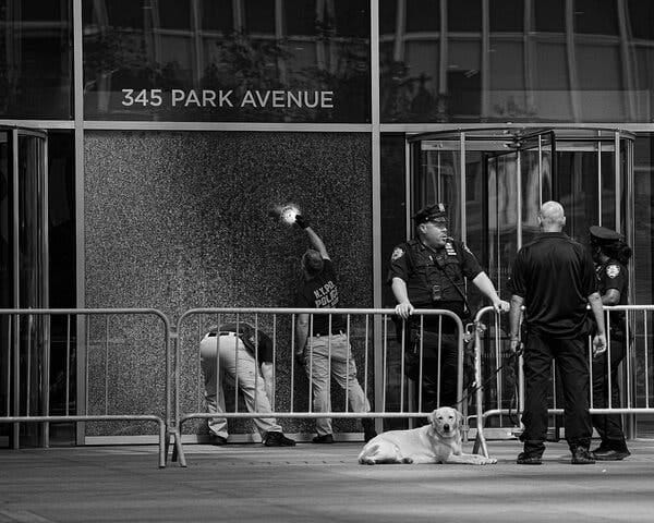 Law enforcement investigators outside a building with “345 Park Avenue” displayed.